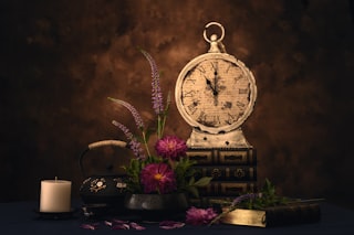 a clock and some flowers