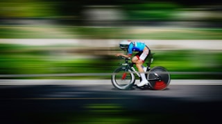 Cyclist racing on a road with motion blur
