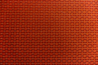 a close up of a red wall with a pattern on it