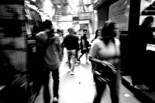 People walking down a blurred city street